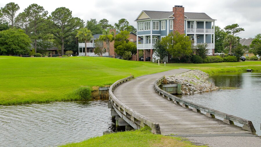 Myrtlewood Golf Club featuring a bridge, a river or creek and a house