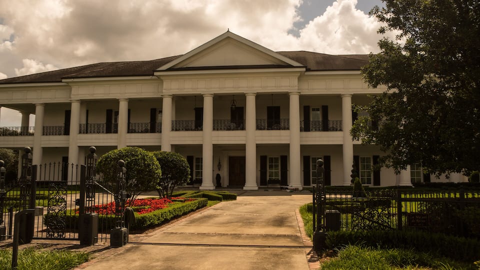 A large white building with columns and a central entrance.