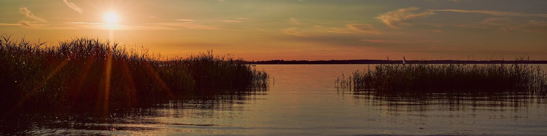 panoramic photo of a sunset over the lake Chiemsee in Germany