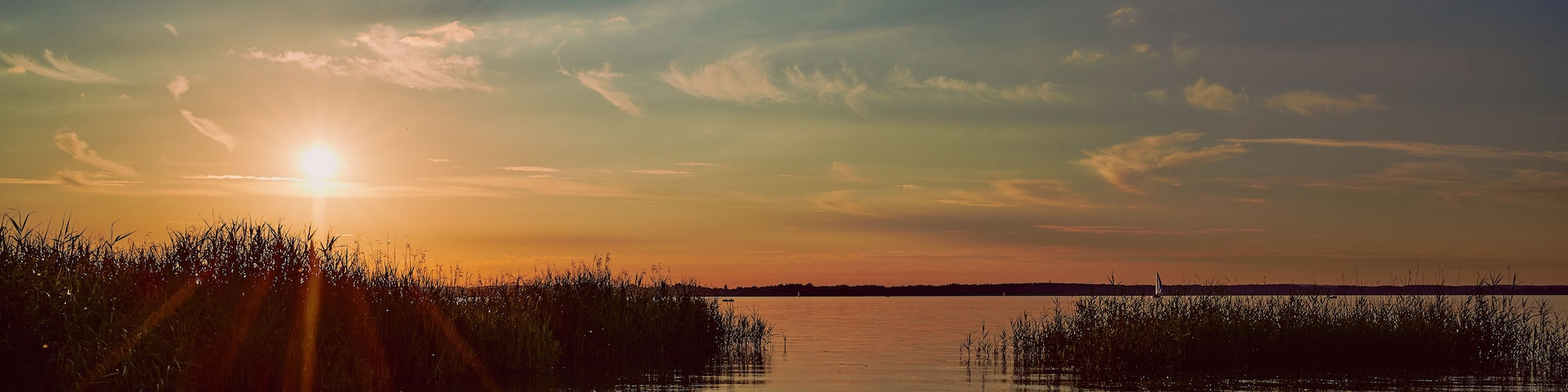 panoramic photo of a sunset over the lake Chiemsee in Germany