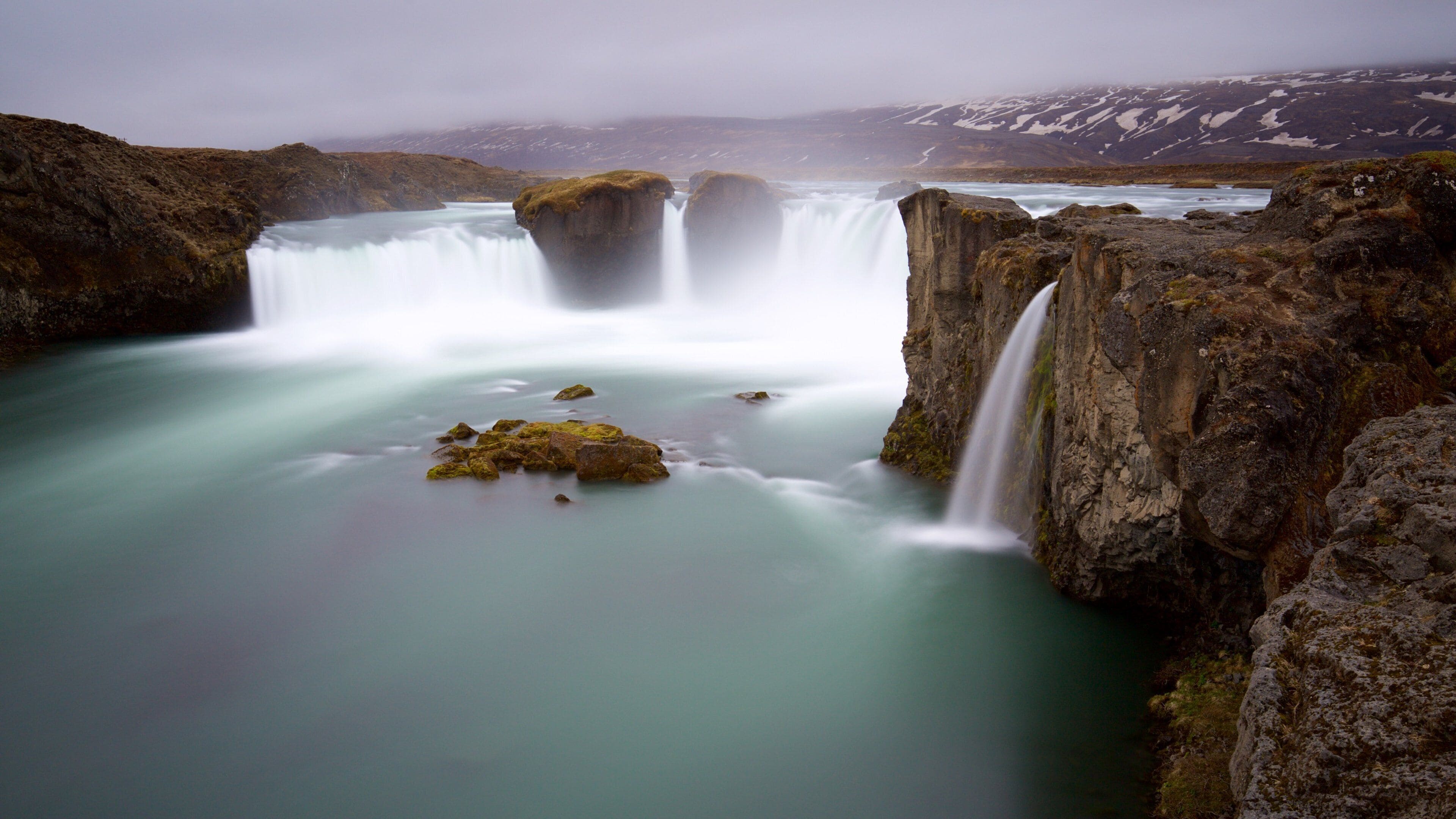 Godafoss which includes a cascade, mist or fog and a river or creek