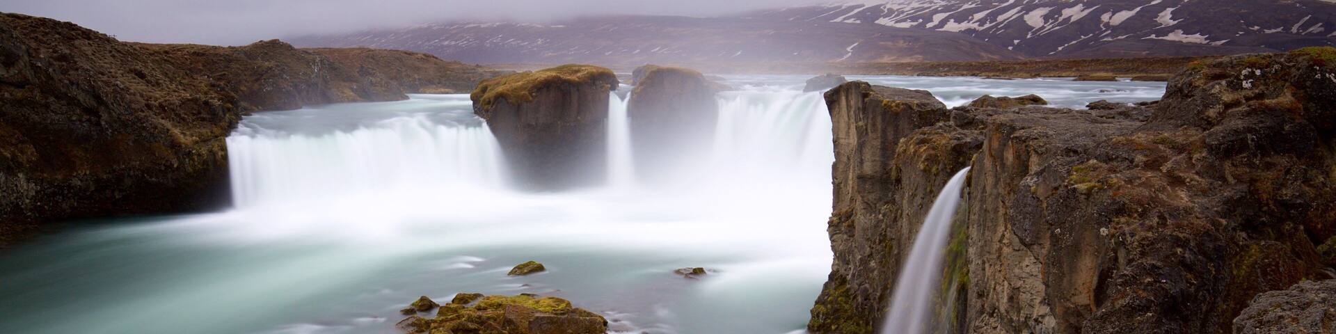 Godafoss which includes a cascade, mist or fog and a river or creek