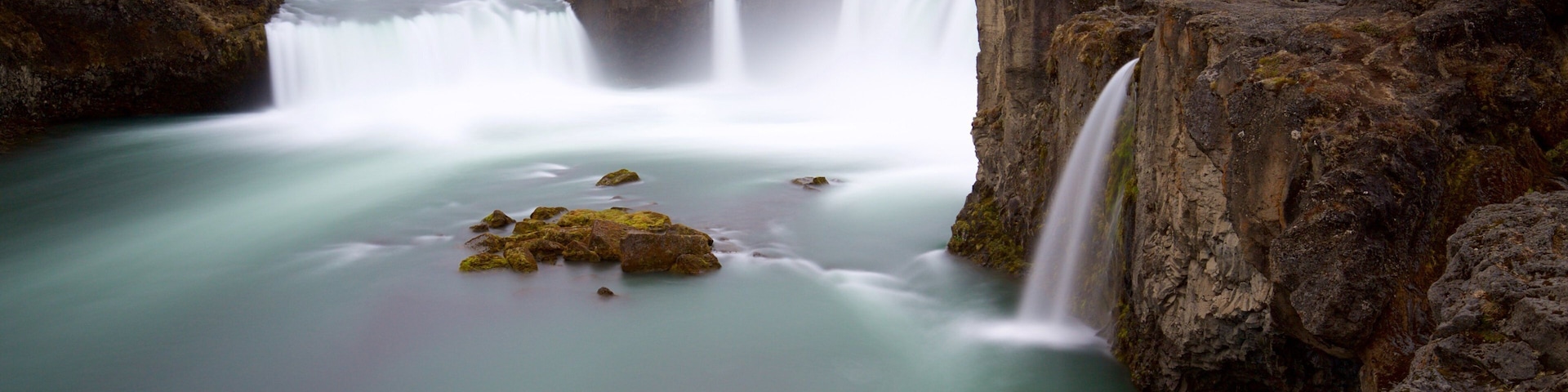 Godafoss which includes a cascade, mist or fog and a river or creek