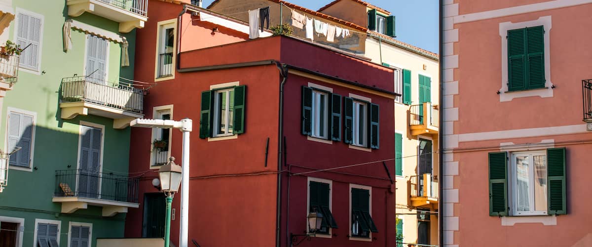 Colorful buildings with balconies and shutters.