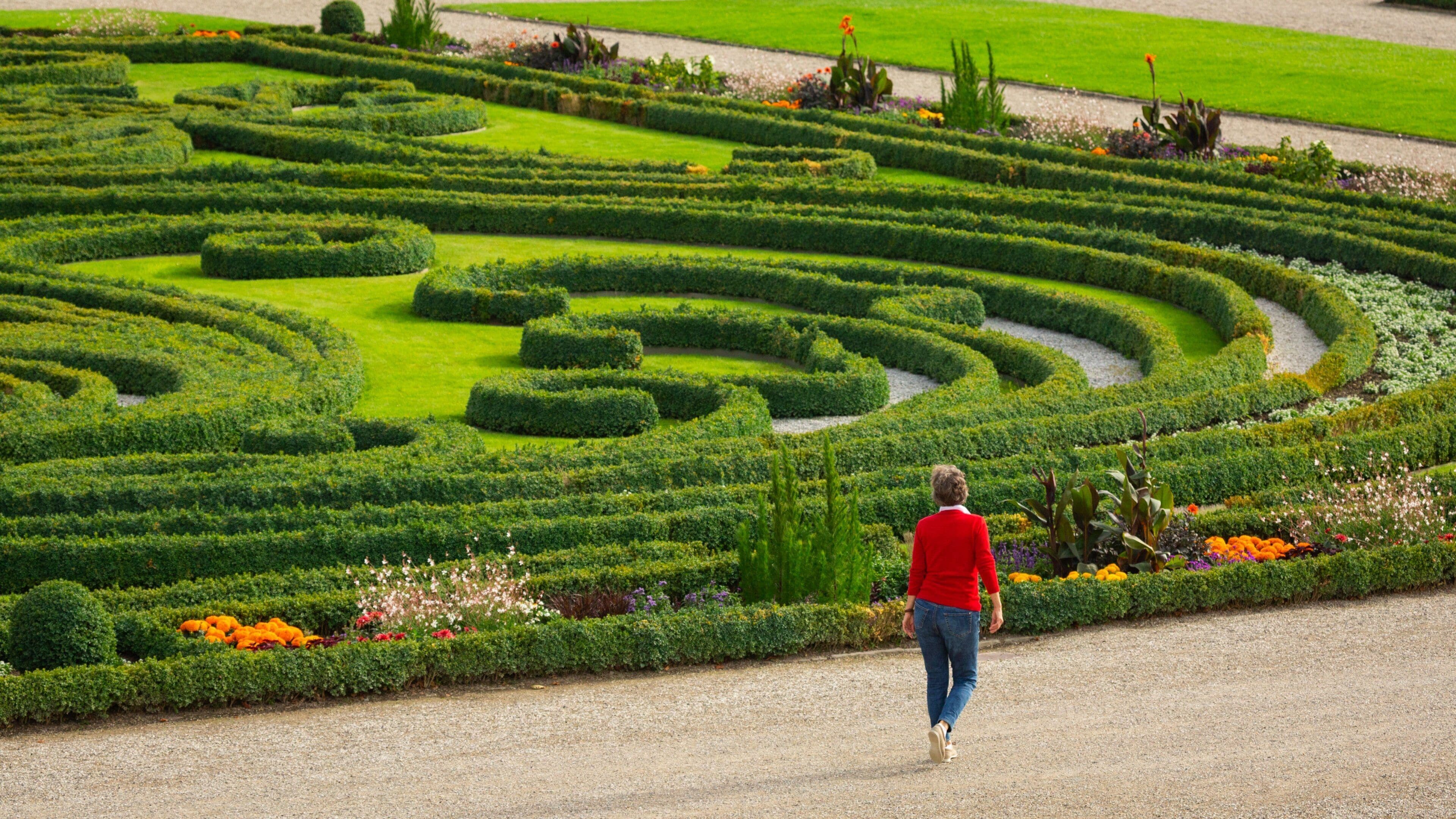 Herrenhausen Gardens featuring a park as well as an individual femail