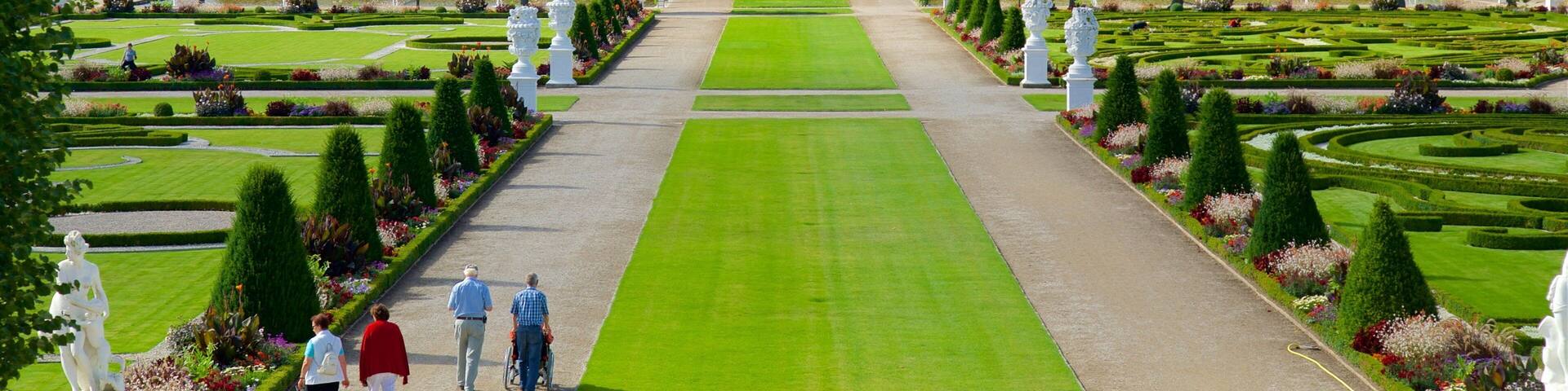 Herrenhausen Gardens featuring a garden as well as a small group of people
