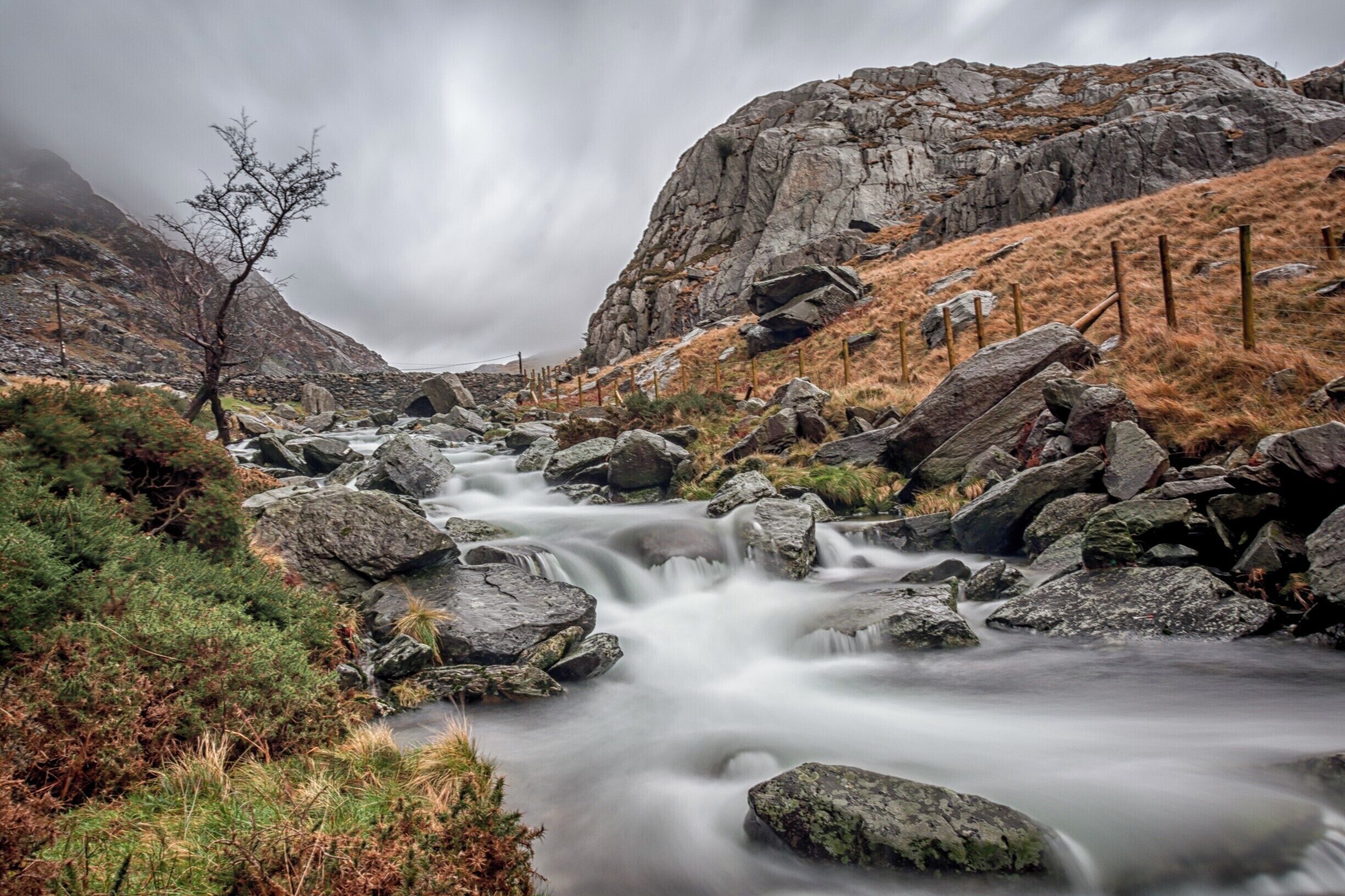 The rugged landscape of North Wales must be seen to be truly appreciated. The weather can chance rapidly and you must be prepared. This long exposure shows the icy cold mountain river flowing down the valley. 