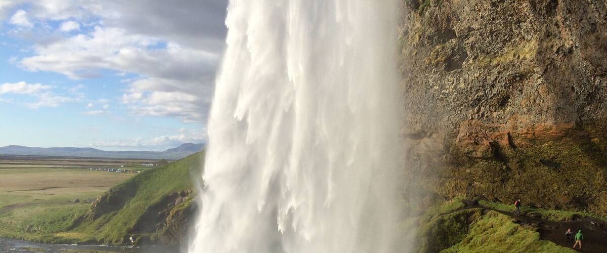 Seljalandsfoss in the afternoon on a sunny day. Walk behind the waterfall for a great view.
