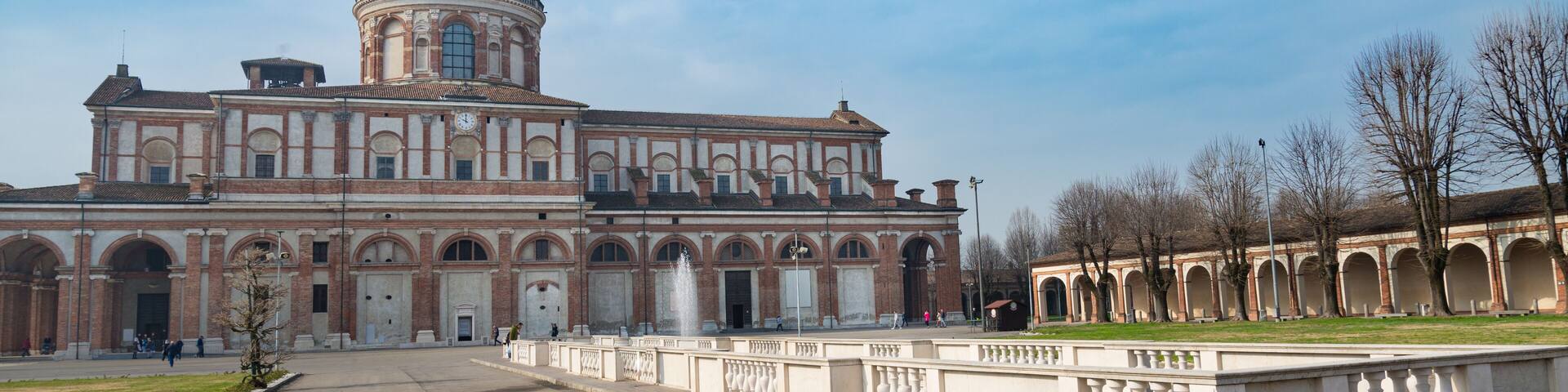The famous ancient Caravaggio's Chatedral, Italy. View of the church from outside, with blue sky and white clouds on the background.