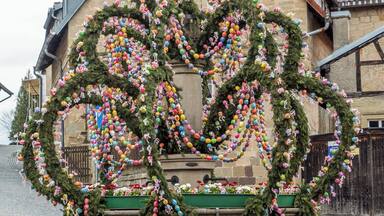 A building adorned with colorful Easter eggs and garlands.