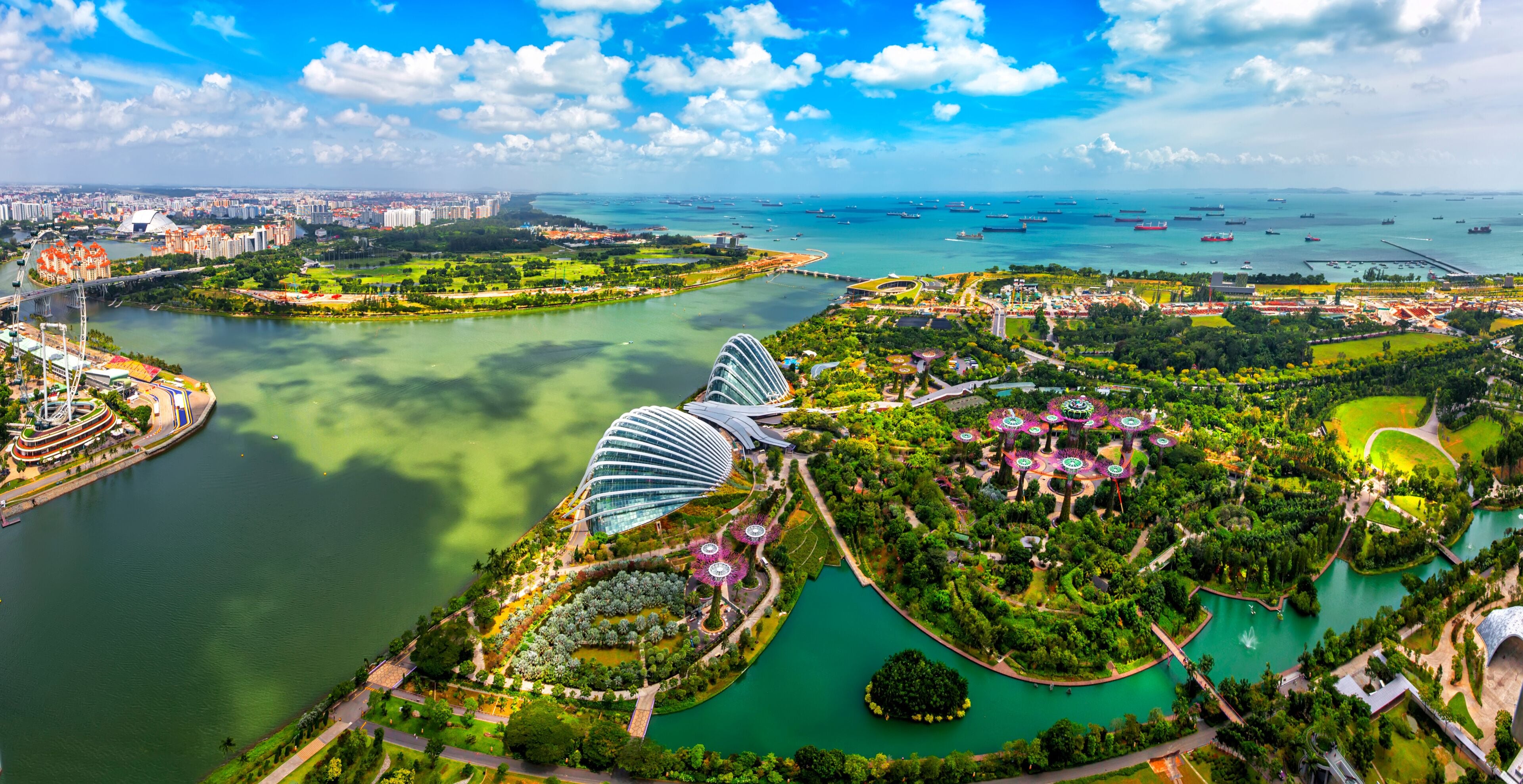 Panorama view of Singapore City skyline in Singapore. Bird eyes view of The Supertree Grove, Cloud Forest & Flower Dome at Gardens by the Bay on August 29,2016 in Singapore. Spanning 101 hectares.
