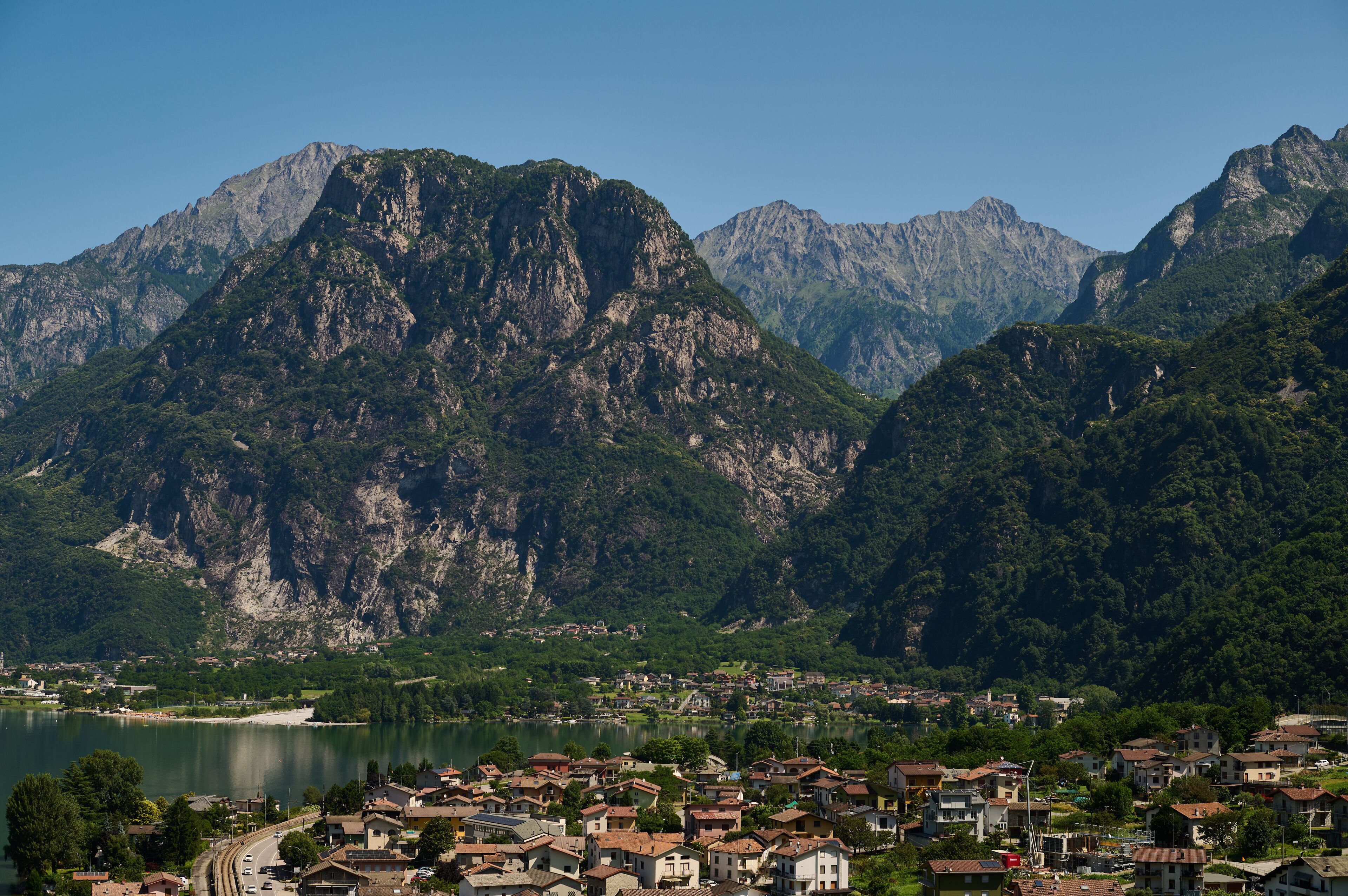 Aerial view of Verceia village on the shore of Lake Mezzola surrounded by the Italian Alps in Lombardy