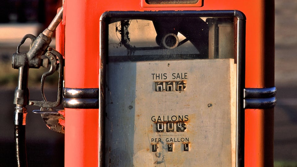 A fuel pump with a price per gallon sign.