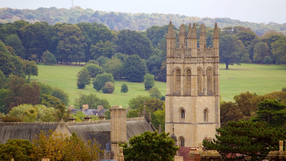 A historic tower with intricate architecture amidst a lush green landscape.