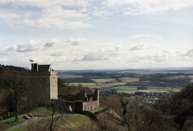 A historic castle on a hill overlooking a valley.
