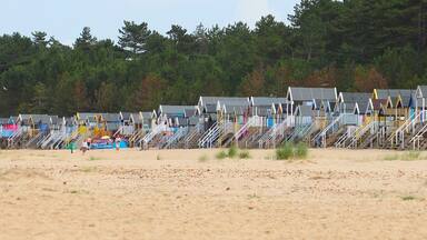 The terrace of colourful beach huts at Wells-next-the-Sea, Norfolk, England, UK.