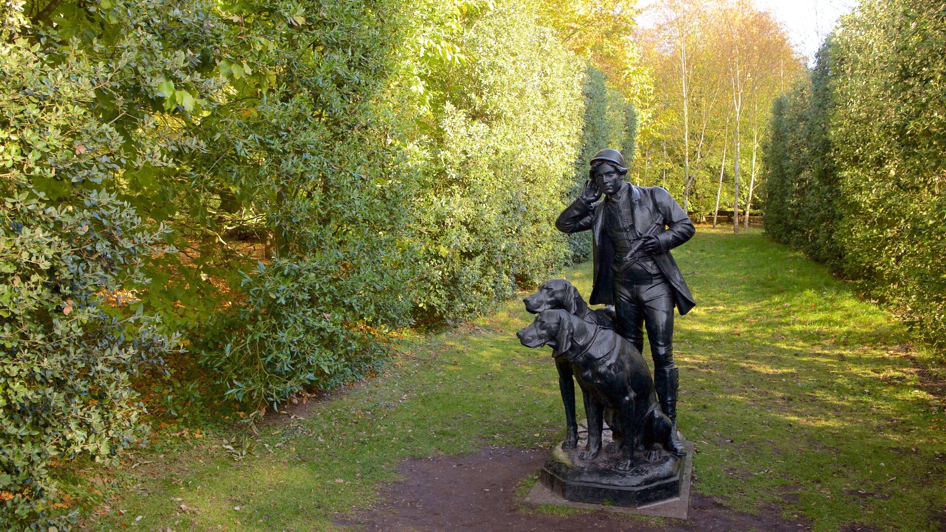 Anglesey Abbey which includes a garden and a statue or sculpture
