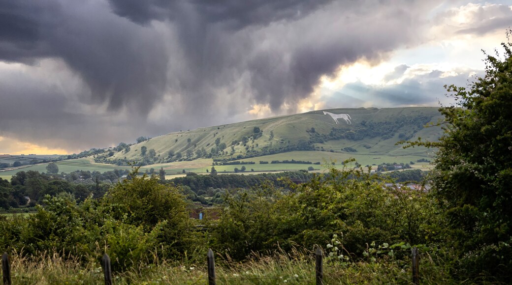 Panoramic view of Westbury White Horse against dramatic sunset sky near Westbury, Wiltshire, UK on 6 July 2021