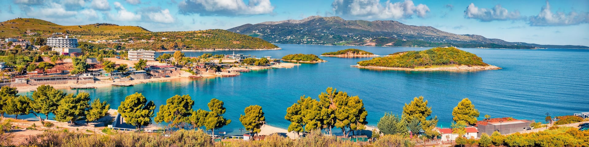 Panoramic seascape of Ionian sea with Corfu island on background. Wonderful spring view of Ksamil village. Spectacular outdoor scene of Albania, Europe. Traveling concept background.