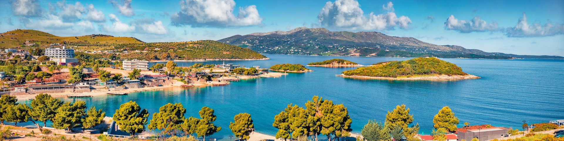 Panoramic seascape of Ionian sea with Corfu island on background. Wonderful spring view of Ksamil village. Spectacular outdoor scene of Albania, Europe. Traveling concept background.
