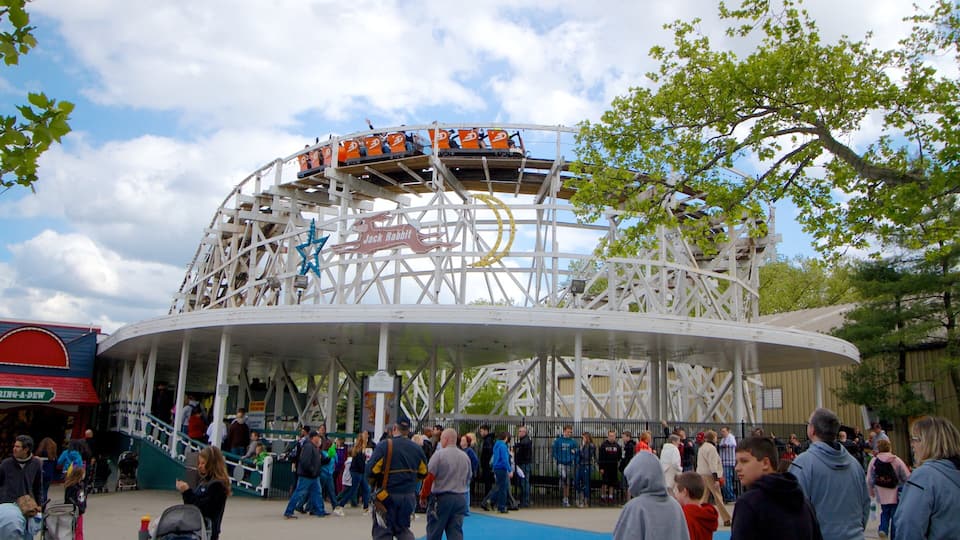 A wooden roller coaster with a star and a rabbit sign, surrounded by a crowd of people.