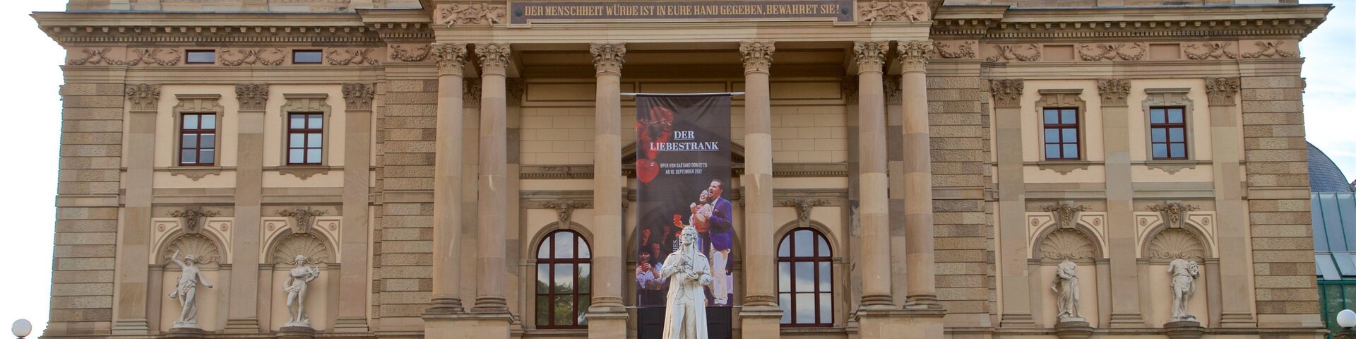 Hessian State Theatre featuring street scenes, heritage architecture and a statue or sculpture
