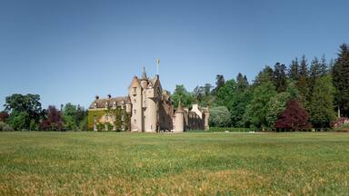Ballindalloch Castle panorama. Wide angle shot of Ballindalloch Castle in the summer. Castle in the forest with huge garden in Scotland.