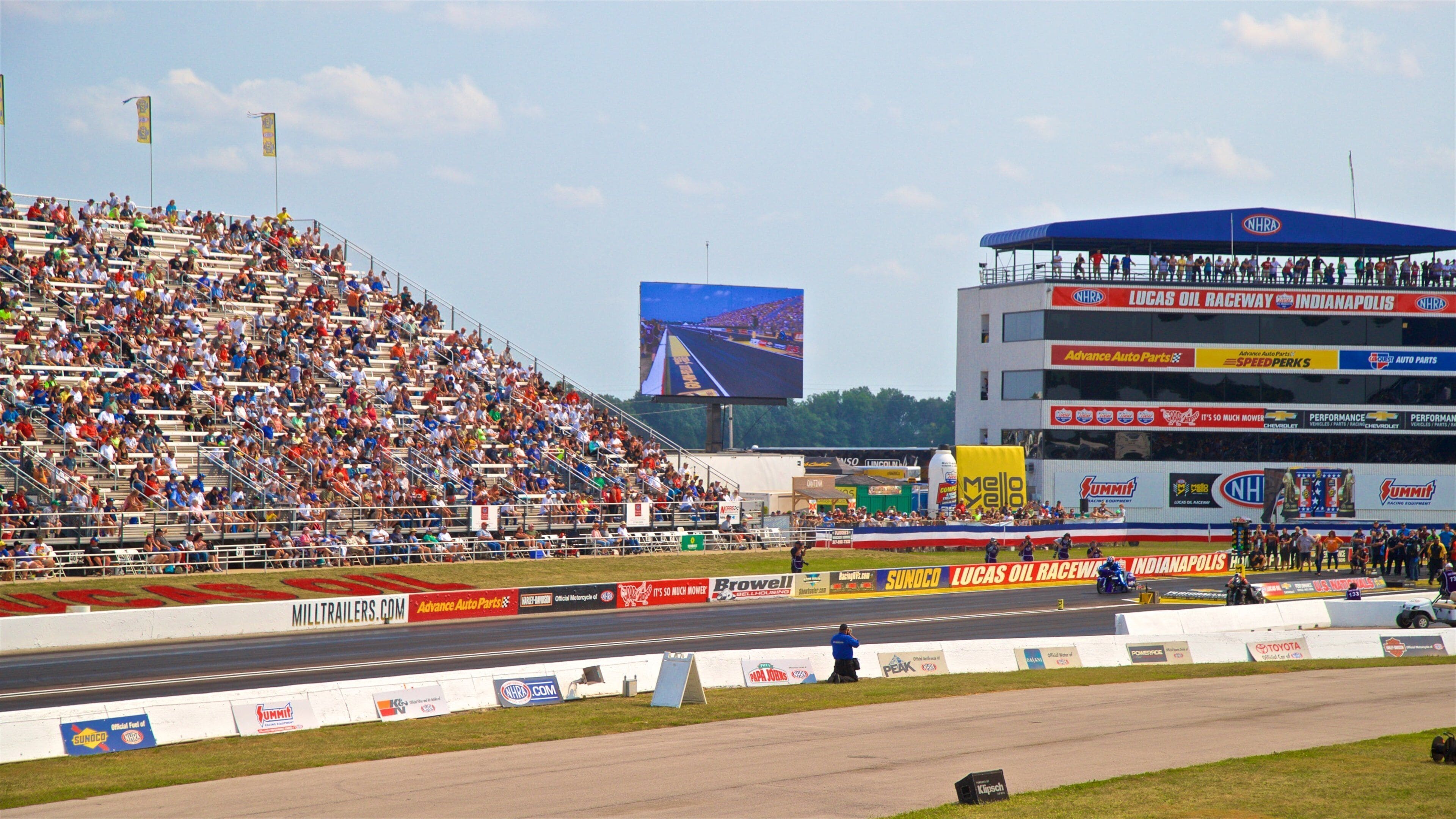 Lucas Oil Raceway as well as a large group of people