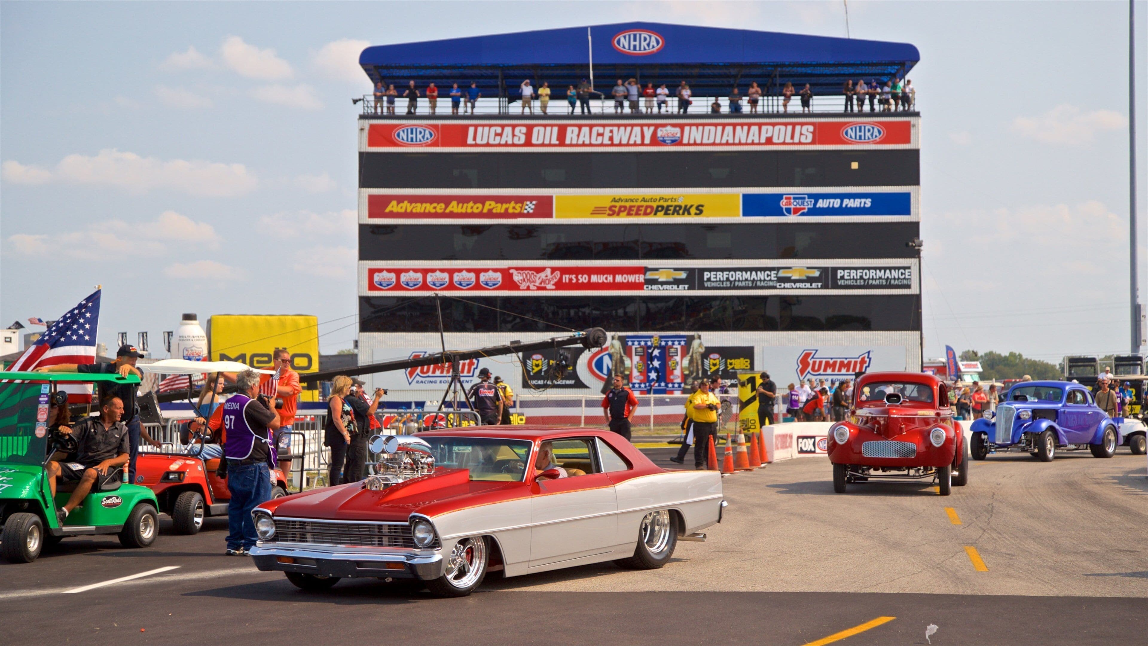 A vintage car event at Lucas Oil Raceway in Indianapolis with classic cars on display.