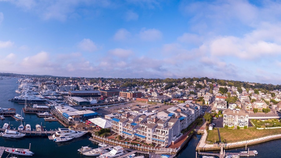 Aerial panoramic shot of the Newport Harbor in Rhode Island with ducked boats and a cloudscape