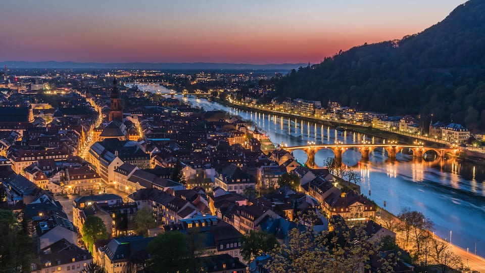 Heidelberg panorama with old city, old bridge and Neckar river after sunset. Beautiful illuminated.