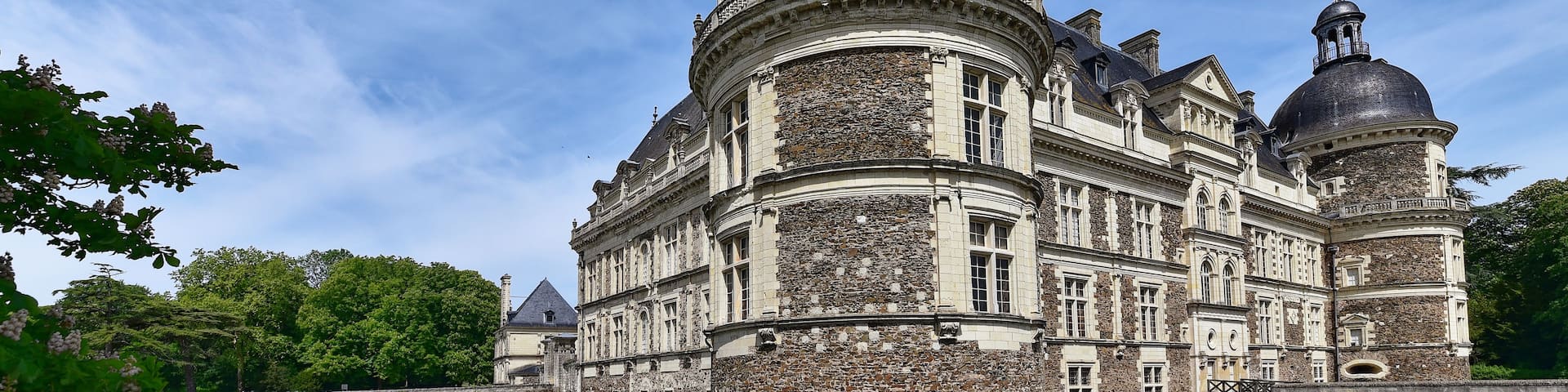 A historic building with a prominent dome and a bridge over a canal.