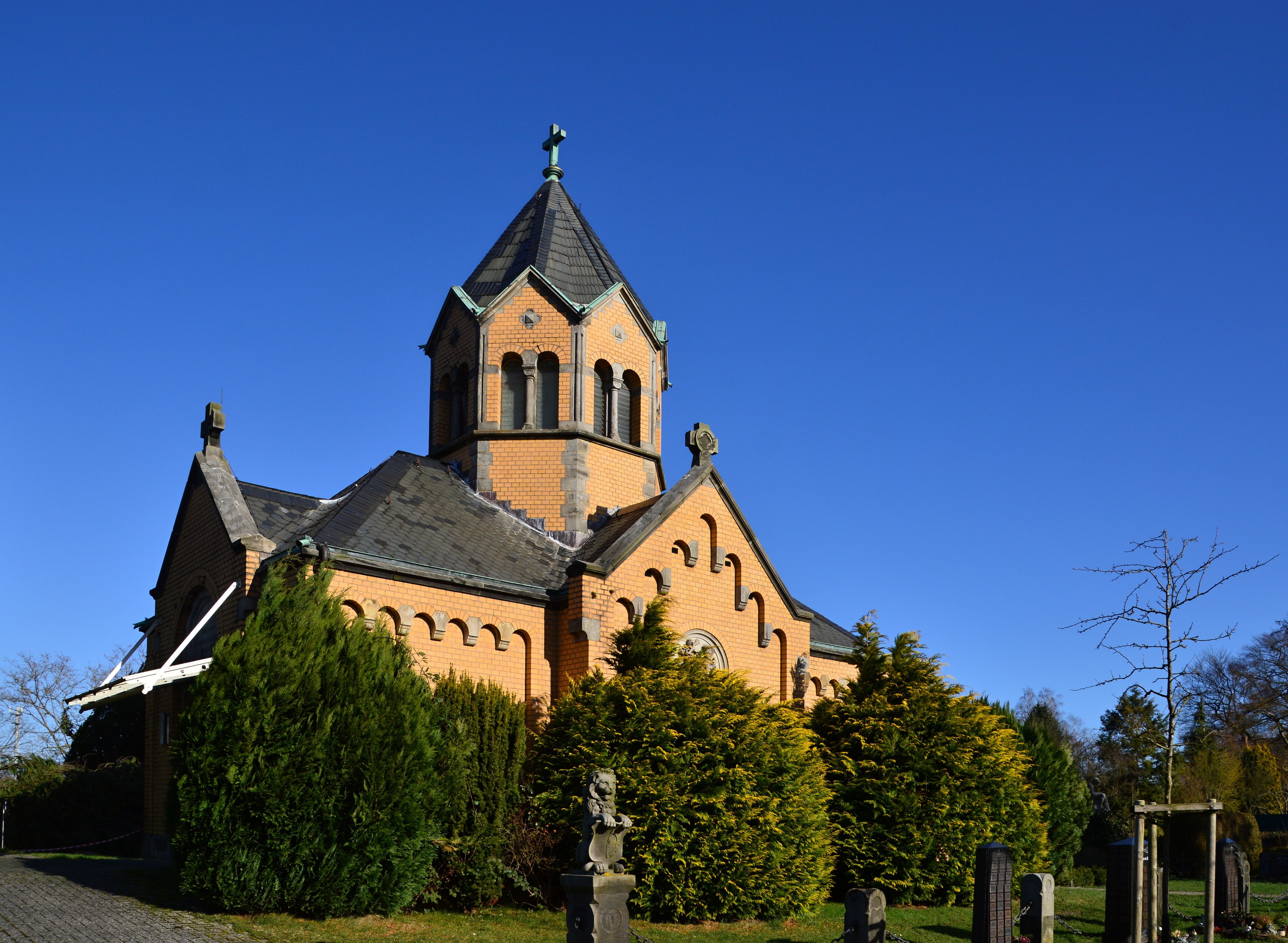A church with a tall steeple and a clock tower.