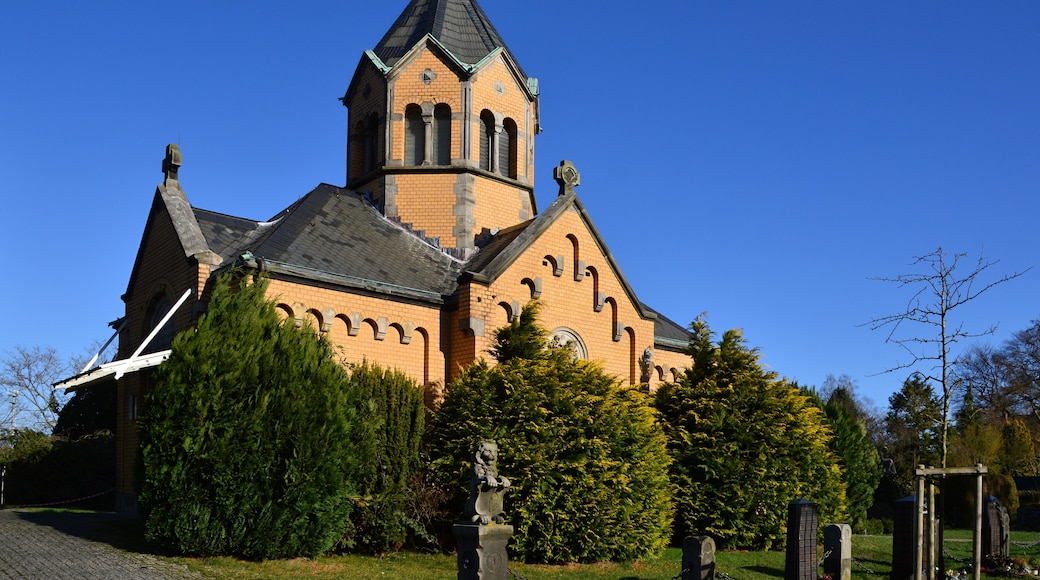 A church with a tall steeple and a clock tower.