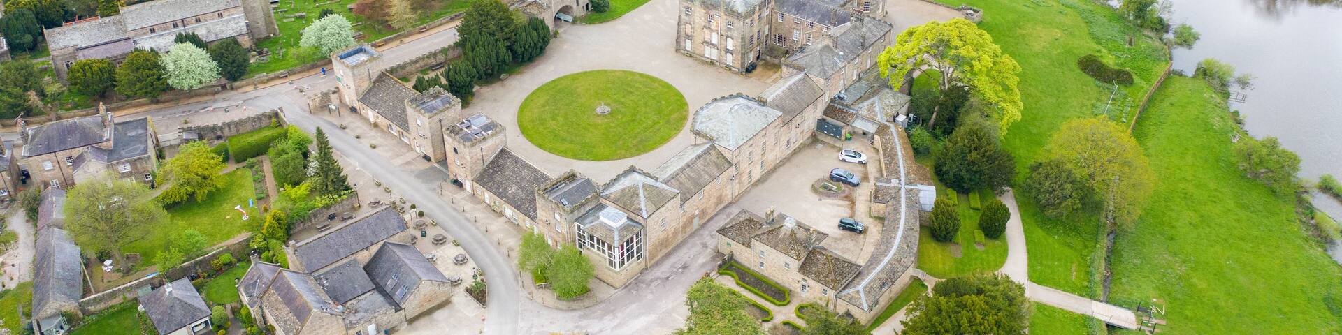 Aerial photo of the small village of Ripley in Harrogate in North Yorkshire in the UK showing the historical Ripley Castle