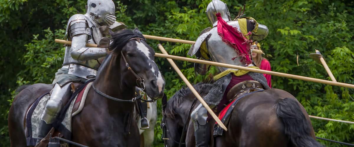 Knights in full armor joust at a bustling medieval faire in Toronto's Black Creek Pioneer Village.