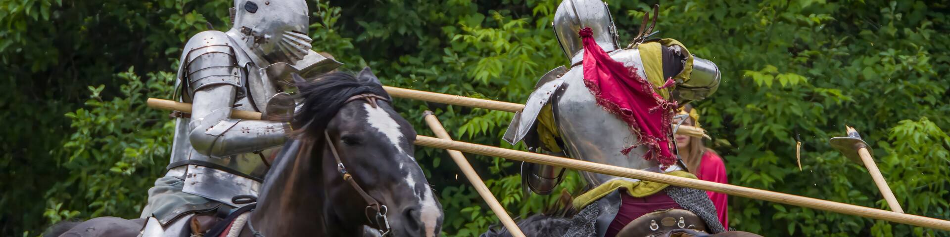 Knights in full armor joust at a bustling medieval faire in Toronto's Black Creek Pioneer Village.