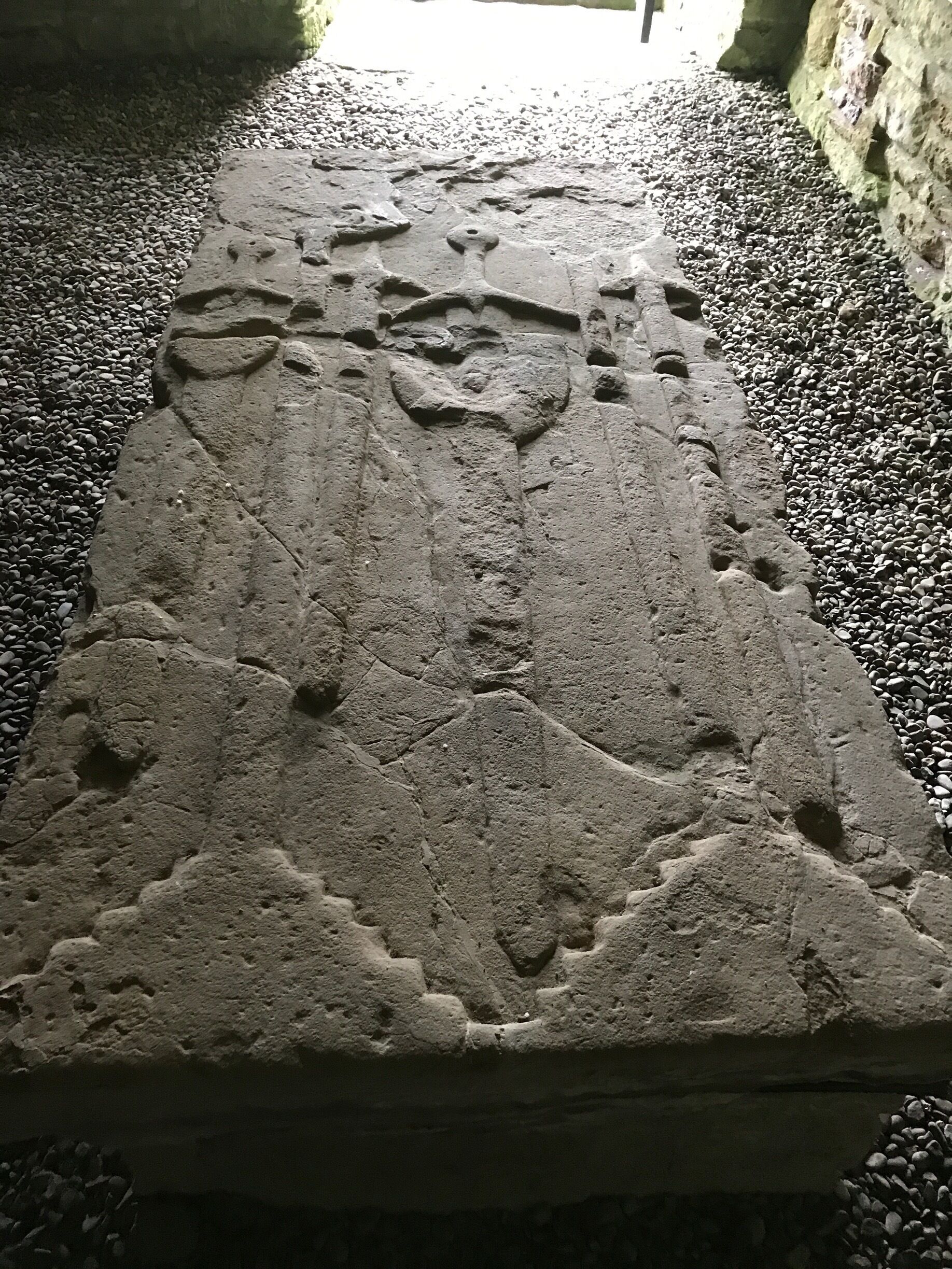Carved medieval tombstone, Possibly of a warrior judging by the swords carved on it.