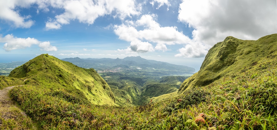 A lush green valley with rolling hills and a clear sky.
