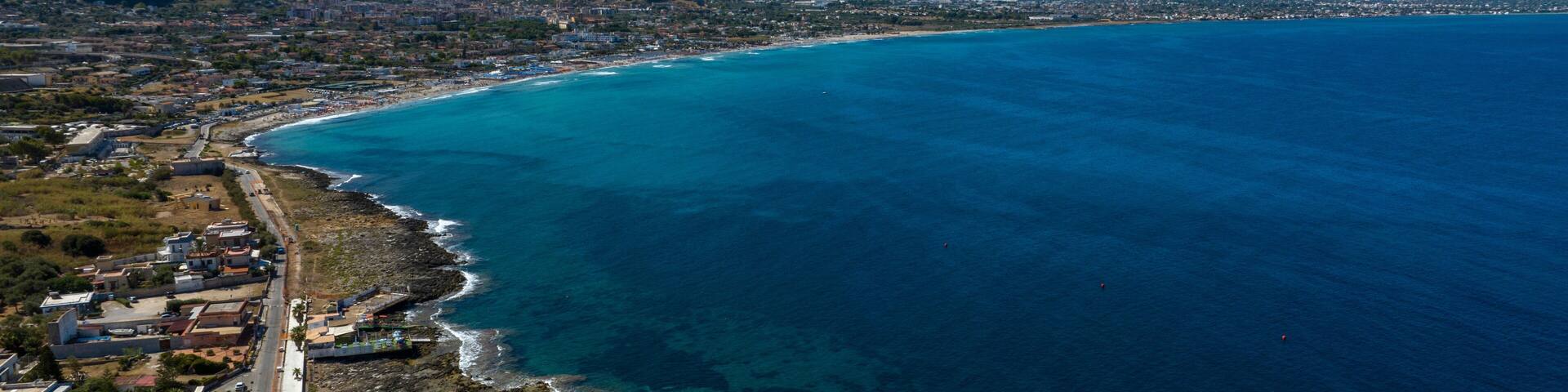 Aerial view of the large and long beach of Capaci, located in the province of Palermo, Sicily, Italy.