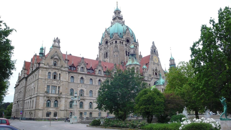 A historic building with ornate architecture, a prominent dome, and a clock tower.