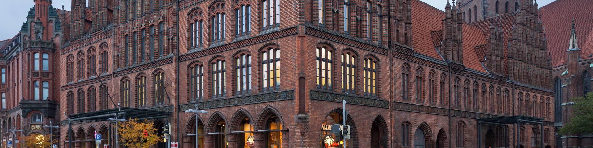 A historic brick building with intricate architecture and a prominent tower.