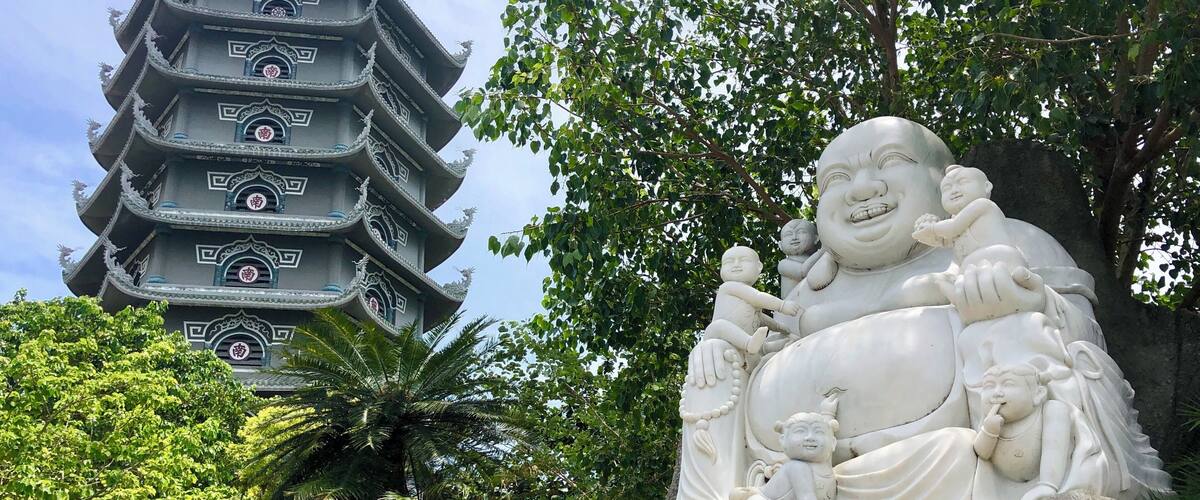 Laughing Buddha with Pagoda behind