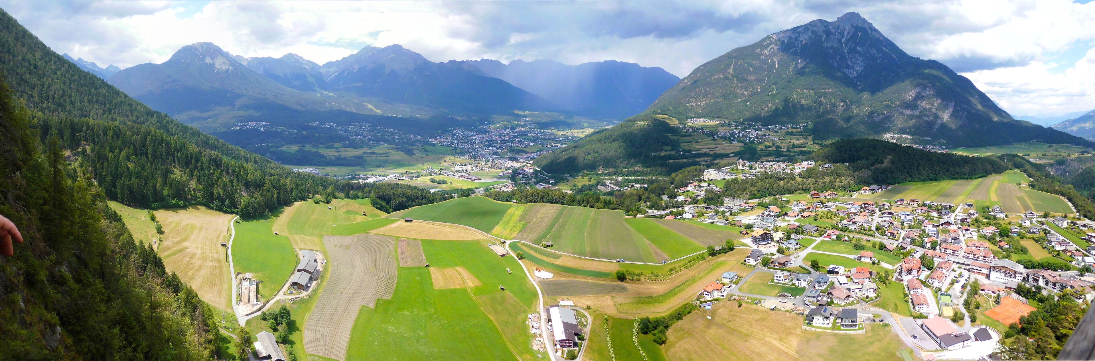 A mountainous landscape with a village nestled in the valley.