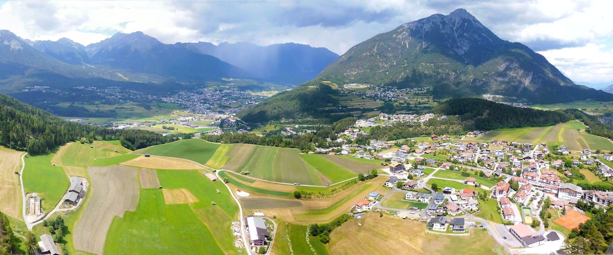 A mountainous landscape with a village nestled in the valley.