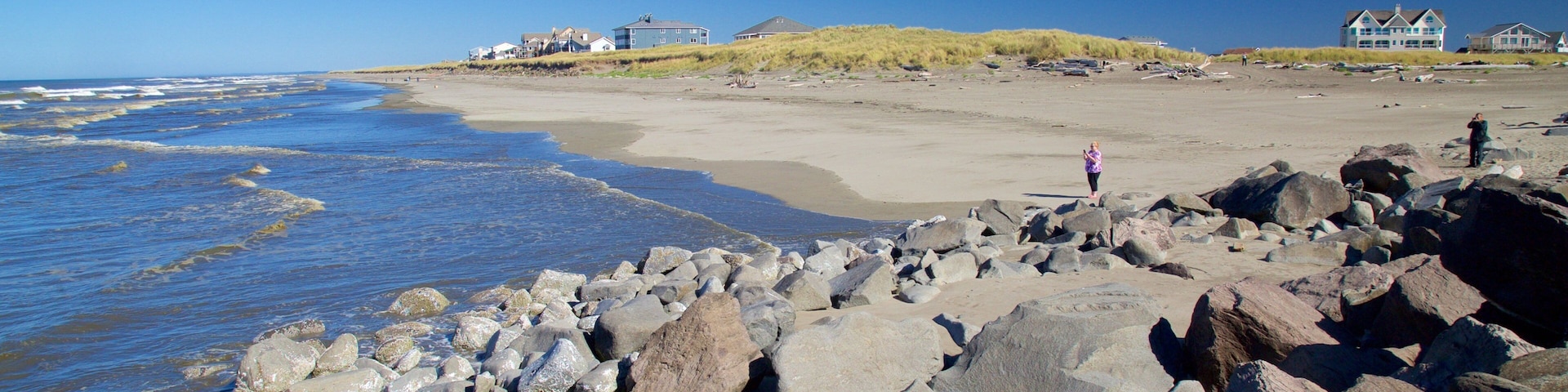 North Jetty which includes rocky coastline and a sandy beach