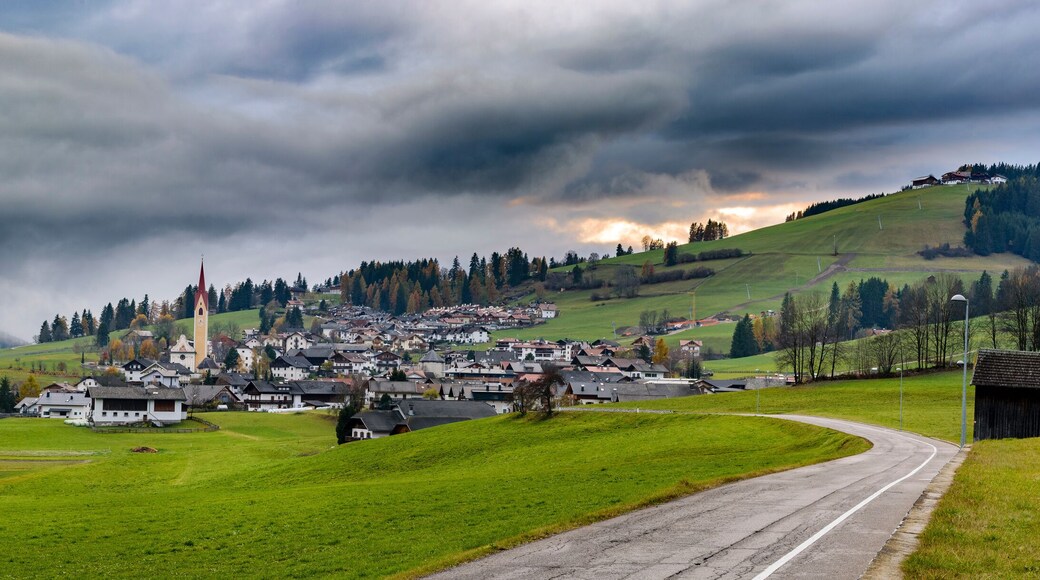 Alpine mountain village in Welsberg Taisten region in Italy during cloudy autumn evening.