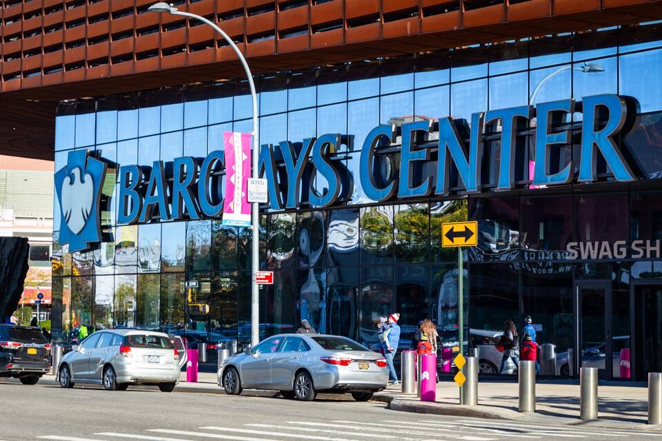 A modern building with large glass windows and the text "BARC" and "MYSTIC CENTER" on the facade.
