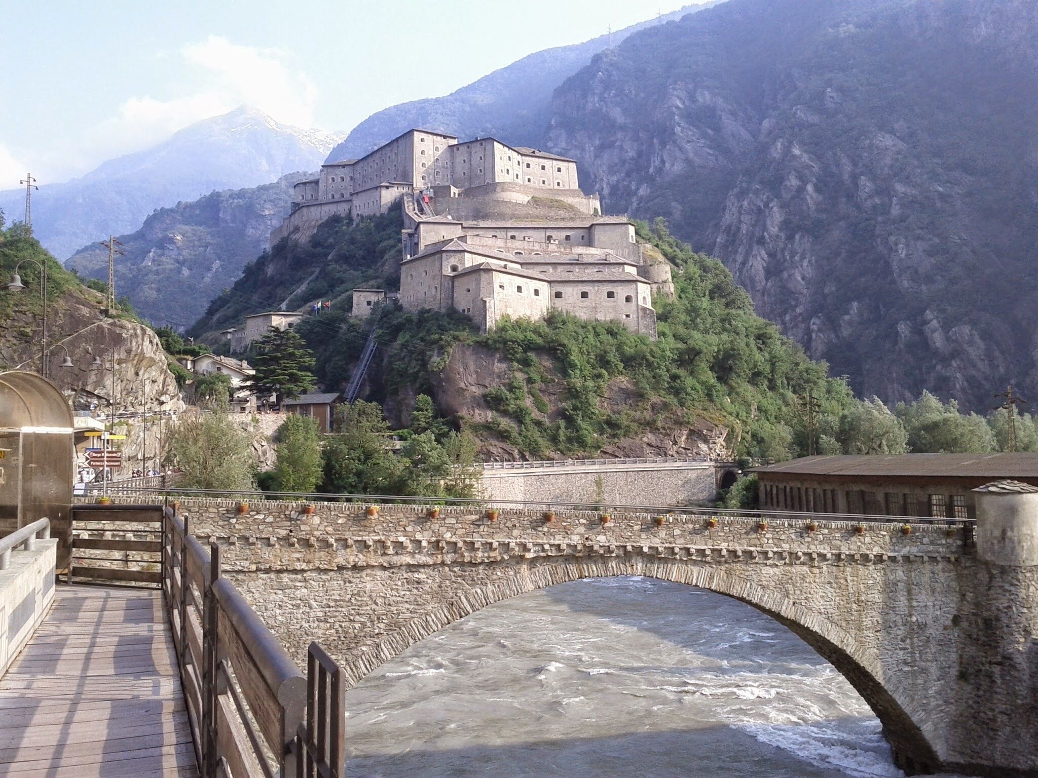 A historic monastery perched on a cliffside overlooking a river.