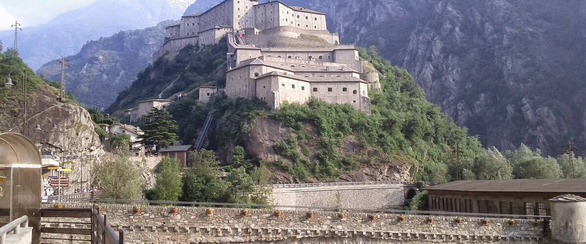 A historic monastery perched on a cliffside overlooking a river.